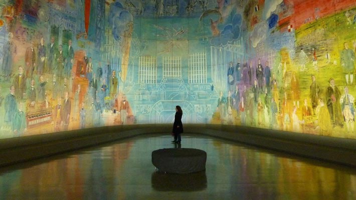 multi color experiential graphic being viewed by a person in silhouette