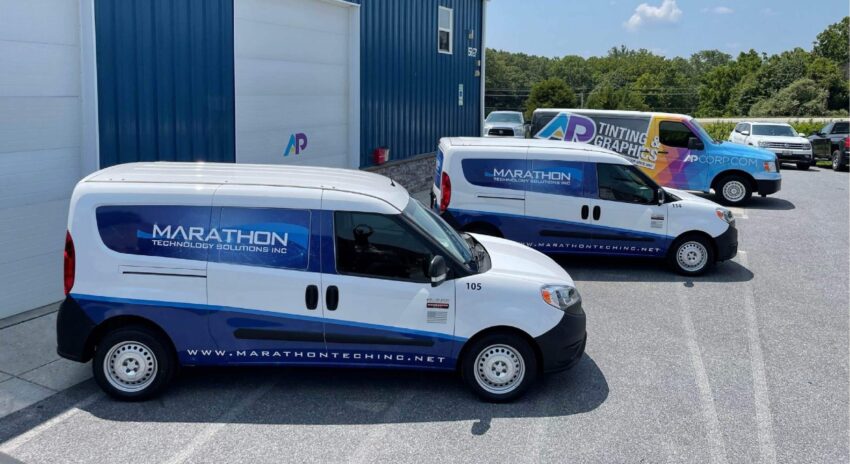 Two service vans with fleet wrap graphics for Marathon Technology Services