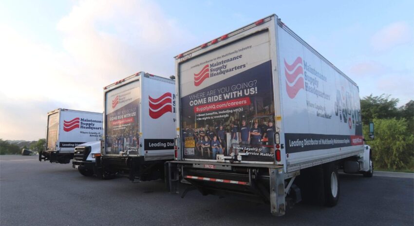 Rear view of a fleet of trucks with custom vinyl wraps installed for Maintenance Supply Headquarters