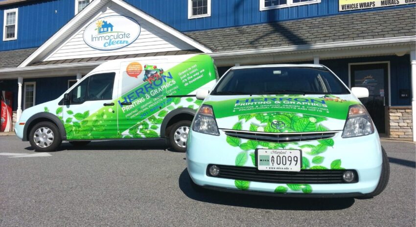 Car and van with custom fleet wraps promoting Herron Printing and Graphics
