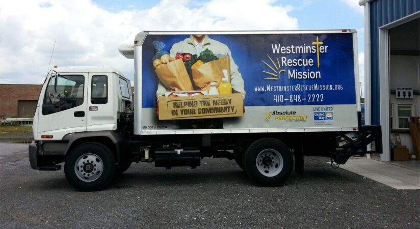Box truck with a custom vinyl wrap design advertising Westminster Rescue Mission