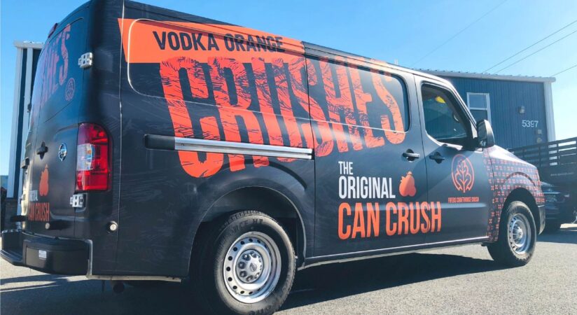 Van with custom black and orange vinyl wrap