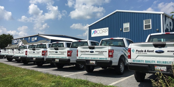 A group of business trucks covered in fleet wraps