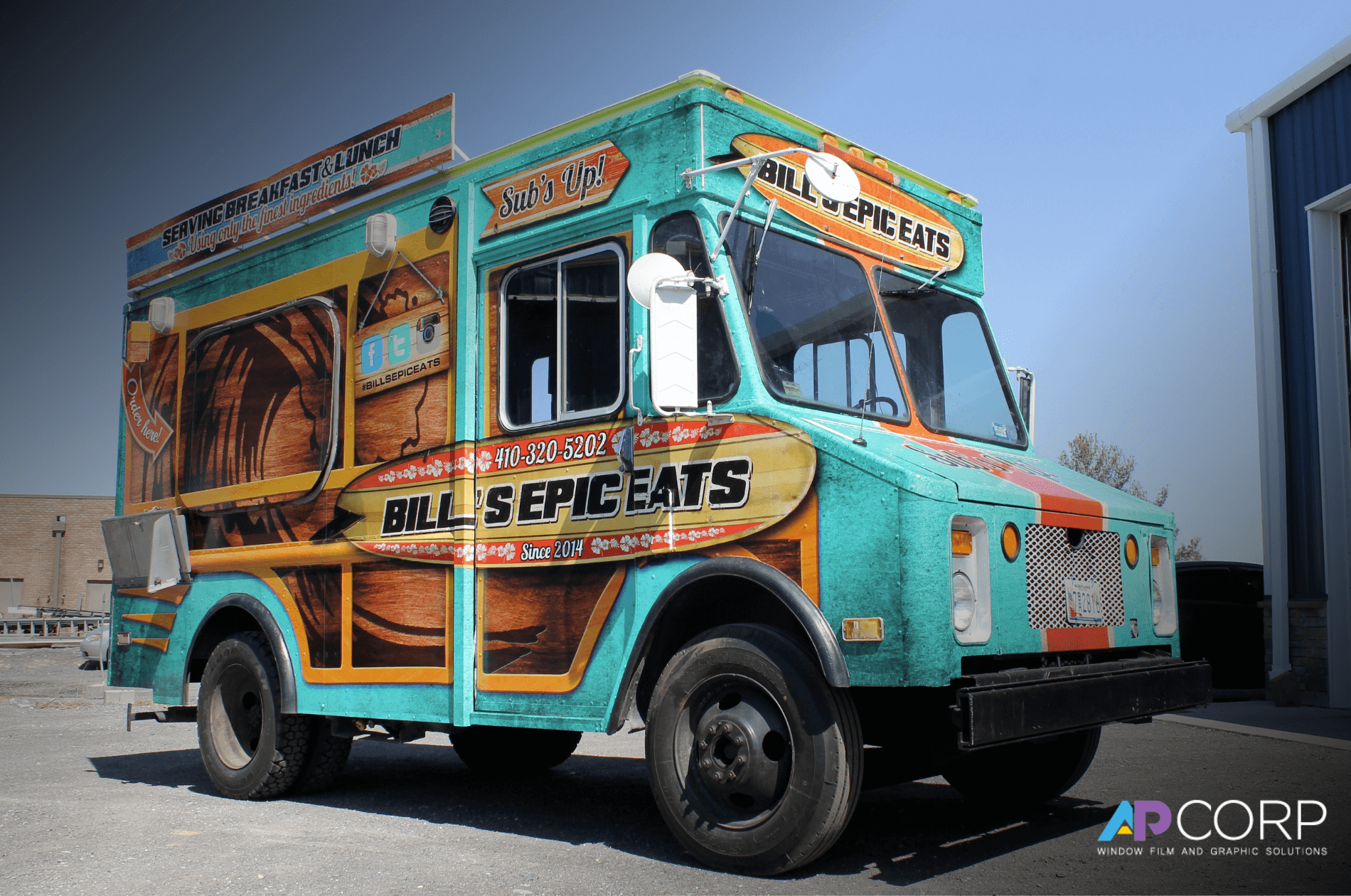 A group of business trucks covered in fleet wraps