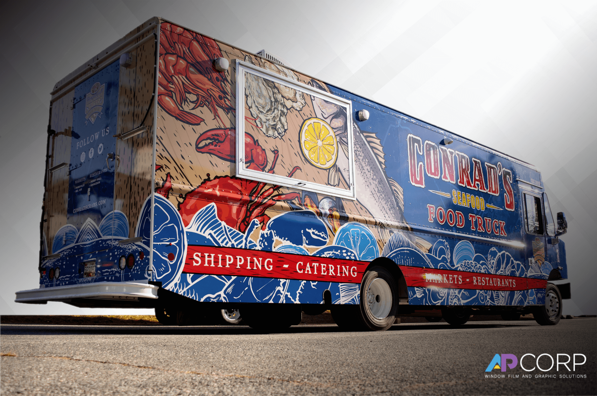 A group of business trucks covered in fleet wraps