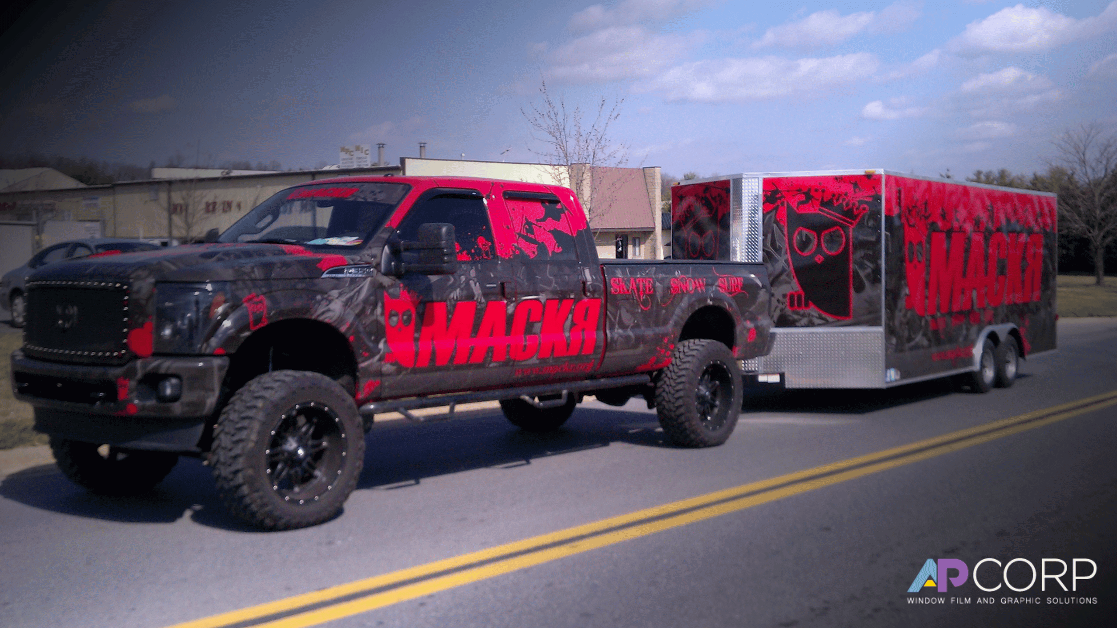 A group of business trucks covered in fleet wraps