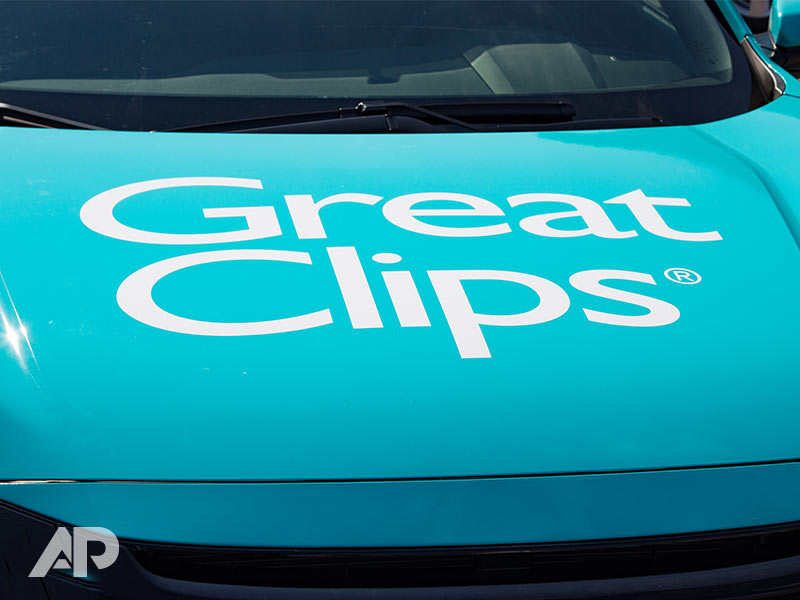 Great Clips advertising wrap on vehicle hood