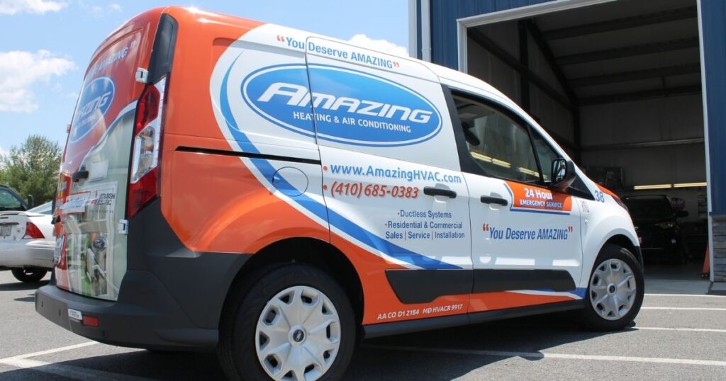 Amazing Heating & Air Conditioning branded transit van with contact info and HVAC services listed on the side.