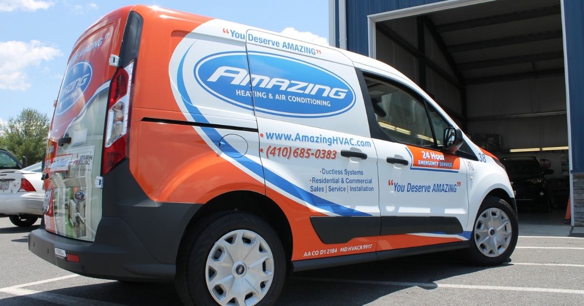 Amazing Heating & Air Conditioning branded transit van with contact info and HVAC services listed on the side.