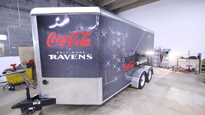 Co-branded Coca-Cola and Baltimore Ravens trailer wrap with bold graphics