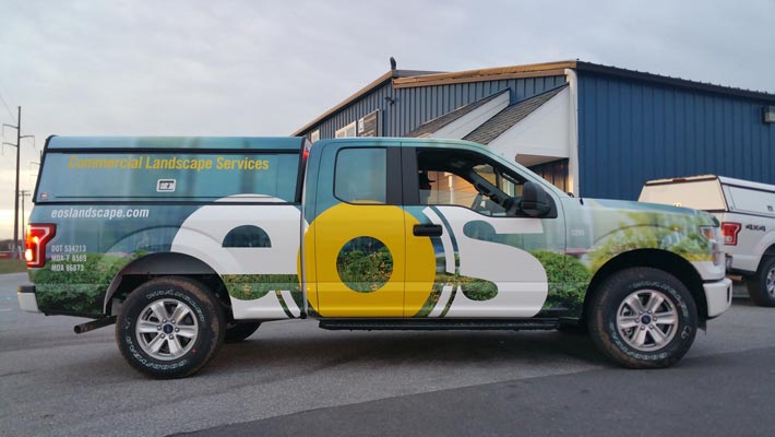 EOS Landscape branded commercial truck wrap showcasing professional landscaping services