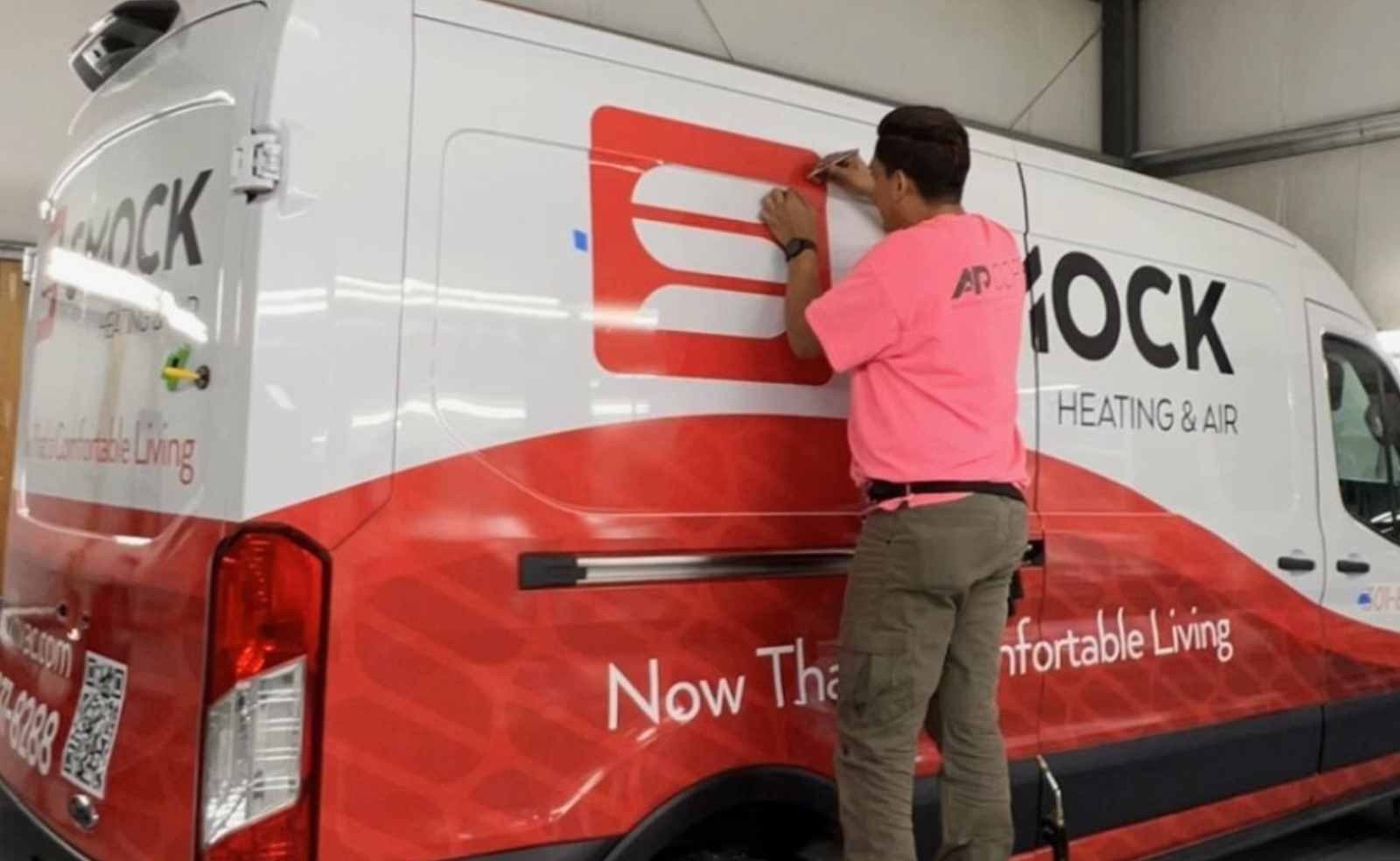 AP Wraps installer applying van graphics, showing the benefits of fleet vehicle branding.