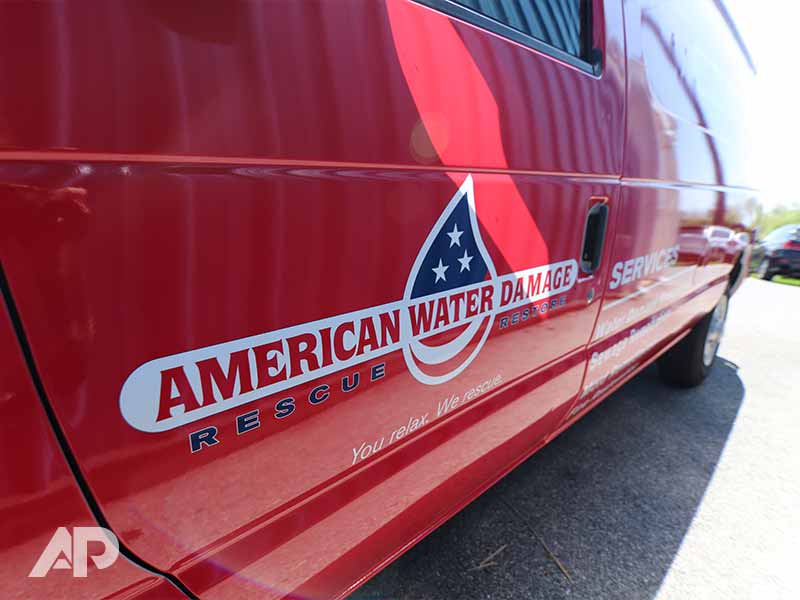 Full side view of American Water Damage truck wrap