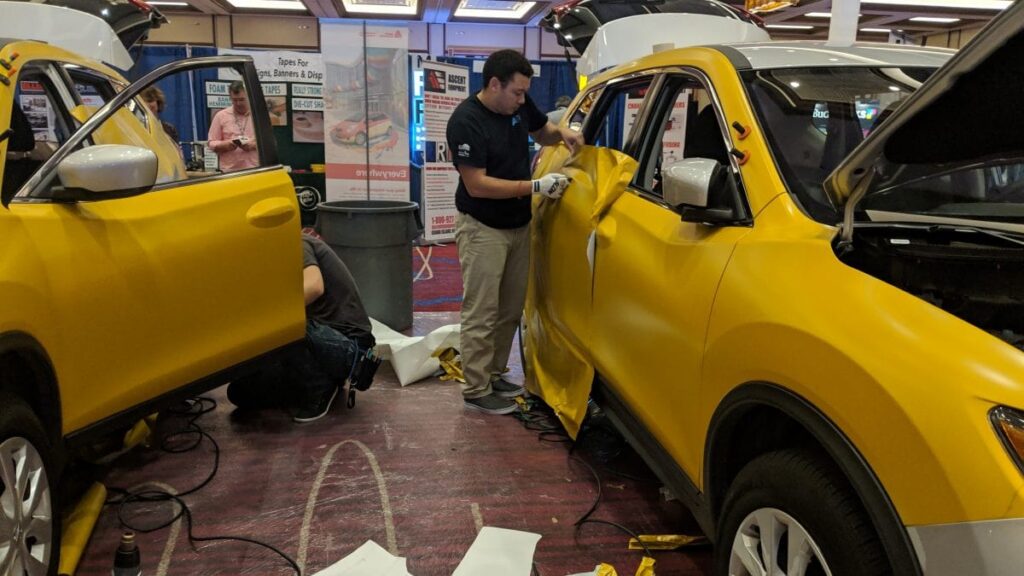 Chris Fong wrapping car at 2018 Sign Exchange Wrap Cup