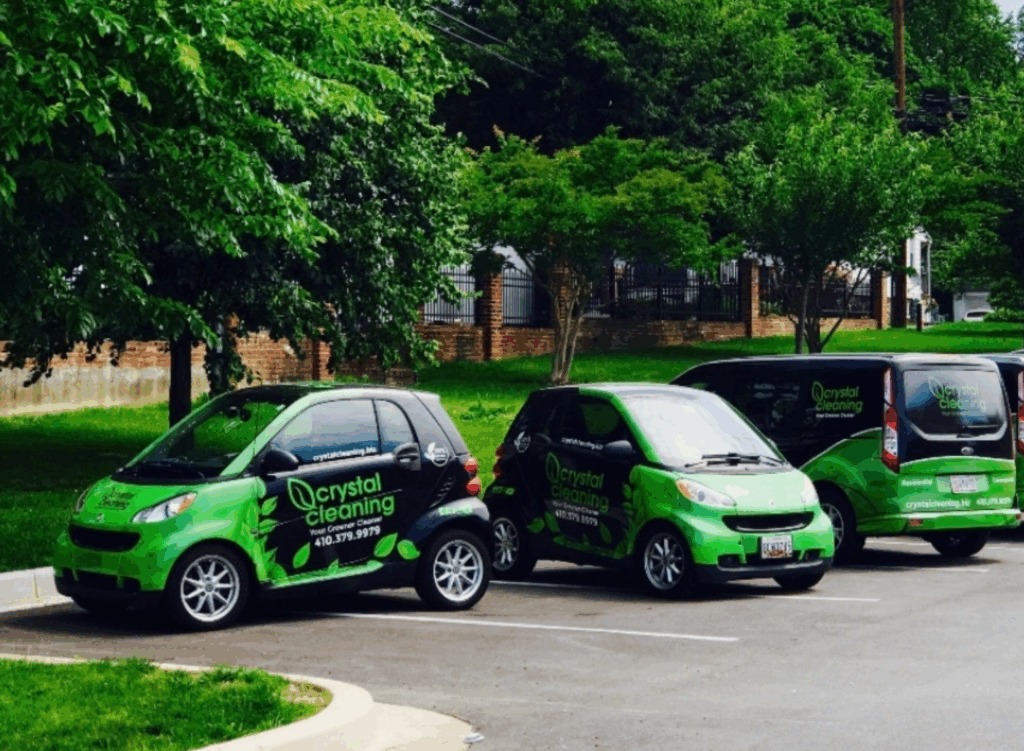 Two cars and a van wrapped in a commercial fleet wrap.