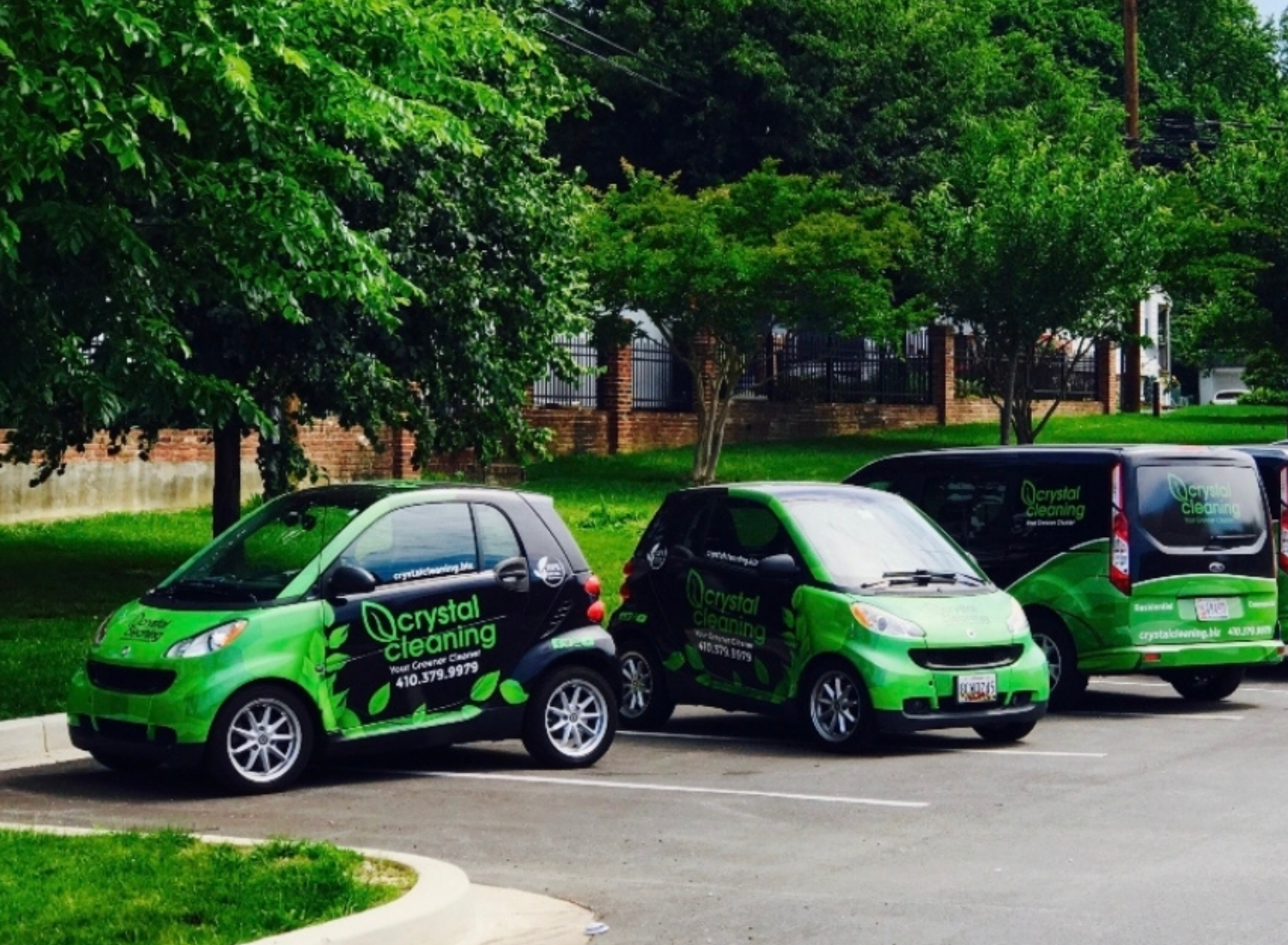 Two cars and a van wrapped in a commercial fleet wrap.